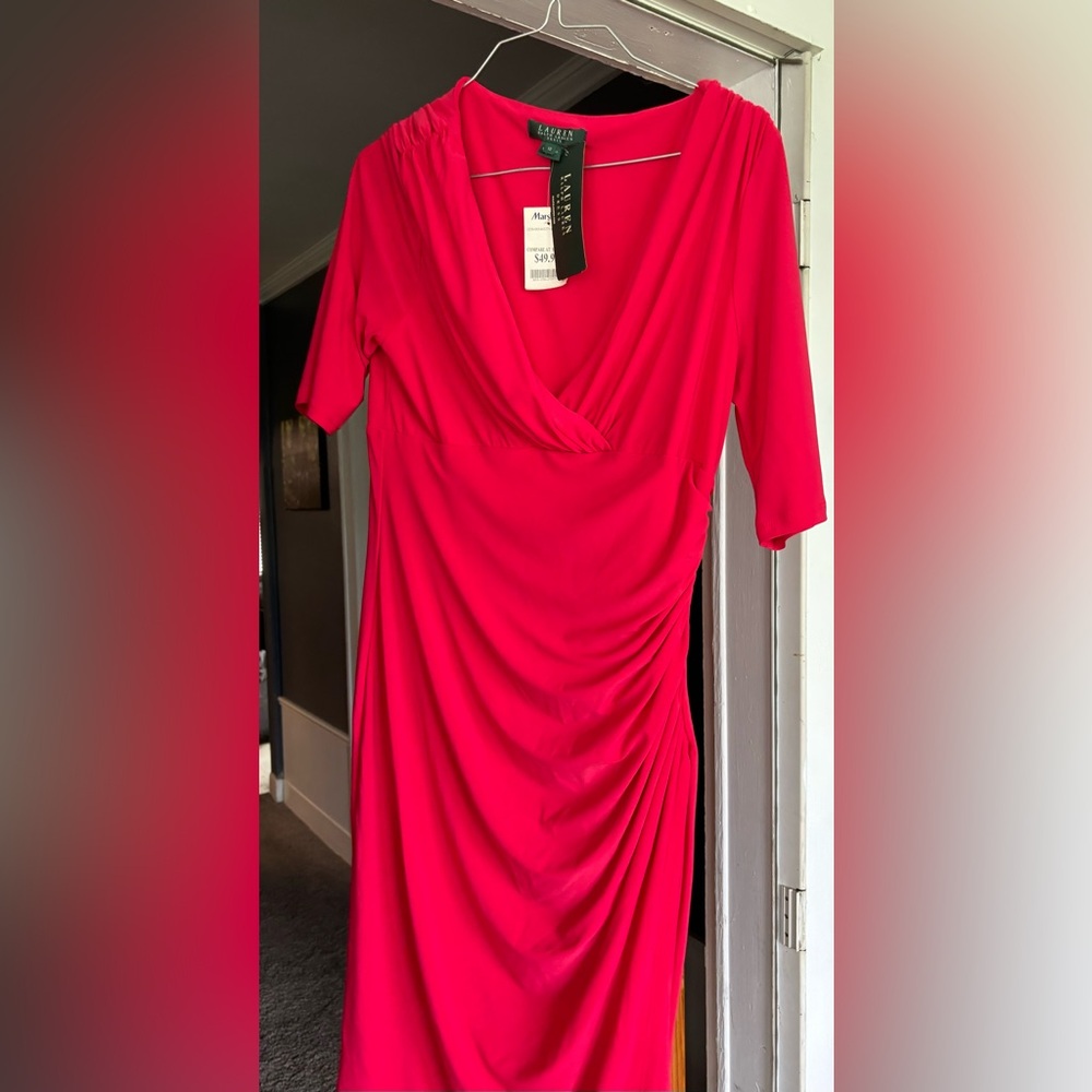 Light weight knit dress with short sleeves. Hem falls just below the knee.